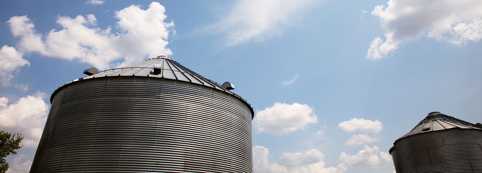 Grain bin against blue skies